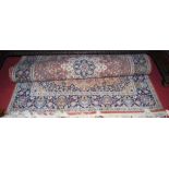 A Persian blue ground woollen rug, with heavy floral decorated ground