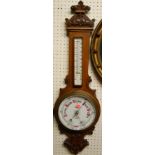 An early 20th century relief carved oak two dial aneroid wheel barometer, 86.5cm