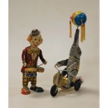 A lithograph printed metal clockwork clown drummer, h.20cm; together with another of a performing