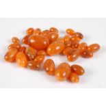 A small quantity of faux amber barrel beads, the largest dia. 3cm, gross weight 51g