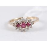 A 9ct ruby and white hardstone cluster ring, the three round rubies surrounded by small round