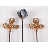 A pair of early 20th century 9ct gold and turquoise set hat-pins; together with a jet set example (