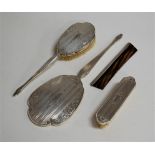 A silver backed hand mirror, hairbrush, clothes brush and comb (4)