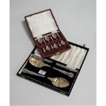 A cased set of six silver coffee spoons; together with a cased pair of EPNS berry spoons (2)