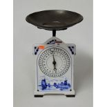 An early 20th century Dutch enamelled kitchen scale, blue and white decorated with windmill and