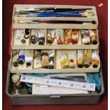 A collection of assorted artists paintbrushes and paints
