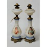 A pair of early 20th century opalescent glass and brass mounted oil lamps, each of baluster form,