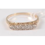 An 18ct gold diamond dress ring, arranged as five old round cut diamonds in a raised line setting,