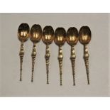 A set of six early 20th century silver gilt spoons, each having a shaped bowl with engraved