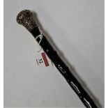A late Victorian walking cane having a hawthorn shaft with embossed silver handle, length 88cm