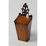 A 19th century mahogany and box wood strung candle box having fret carved upper section to