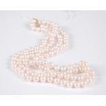 A cultured pearl knotted double string choker, having 9ct gold clasp, 45cm