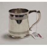 A George V silver christening mug, with banded decoration and C-scroll handle