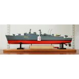 A scratch built and painted wooden model of the Royal Naval cruiser The Devonshire on an oak