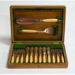 An oak canteen containing six place setting of fish knives and forks with servers, all with faux