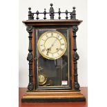 A late 19th century continental walnut and ebonised cased mantel clock having a painted dial with