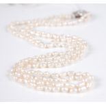 A cultured seed pearl double string necklace, on 9ct gold and white sapphire set clasp