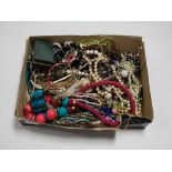 A large collection of mainly modern costume jewellery to include various beaded necklaces, bangles