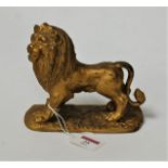 A Victorian gilt metal figure of a lion in standing pose on naturalistic base, height 15cm