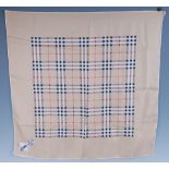 A Burberry silk scarf, with typical check pattern, 76 x 76cm, together with another Burberry style