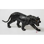 A 20th century leather clad model of a puma in stalking pose, length 41cm