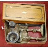 A box of assorted plated wares, to include claret jug, cased carving set, pair of candlesticks etc