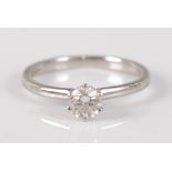 A contemporary platinum diamond solitaire ring, the six claw set brilliant weighing approx 0.33
