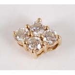 A yellow metal and diamond set pendant, of lozenge shape, arranged as four claw set brilliants,
