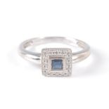 An 18ct white gold, sapphire and diamond square cluster ring, featuring a centre square cut sapphire