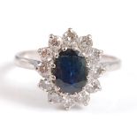 A 9ct white gold and sapphire oval cluster ring, the centre oval sapphire dimensions approx 7.75 x 6