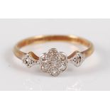 A vintage 18ct gold and platinum diamond dress ring, arranged as seven small pavé set round cut