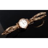 A lady's 9ct yellow gold Omega manual wind wristwatch, the round cream baton dial fitted to a
