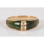 A yellow metal, spinach jade and diamond ring, centre set with three small round cut diamonds