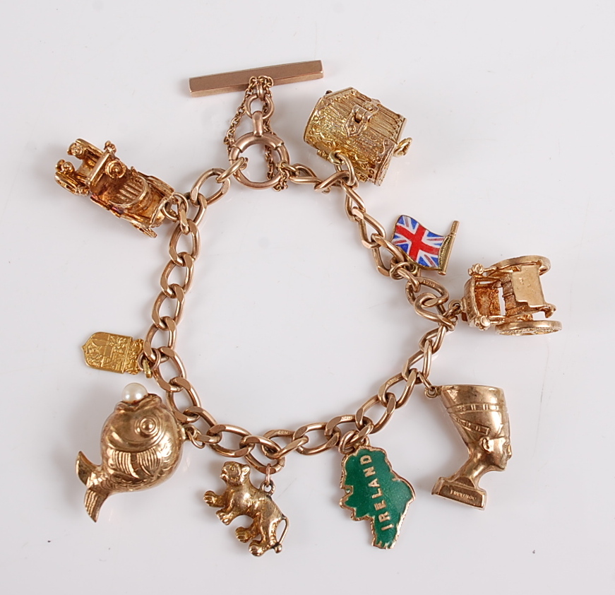 A 9ct yellow gold curb link charm bracelet, the charms to include an opening treasure chest, a Union