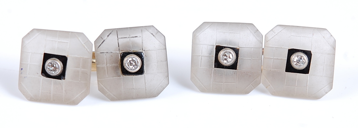 A pair of double ended cuff links , each with two octagonal carved chalcedony plates with black