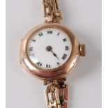 A lady's 9ct yellow gold Rolex manual wind wristwatch, the round white enamel Roman dial fitted to a