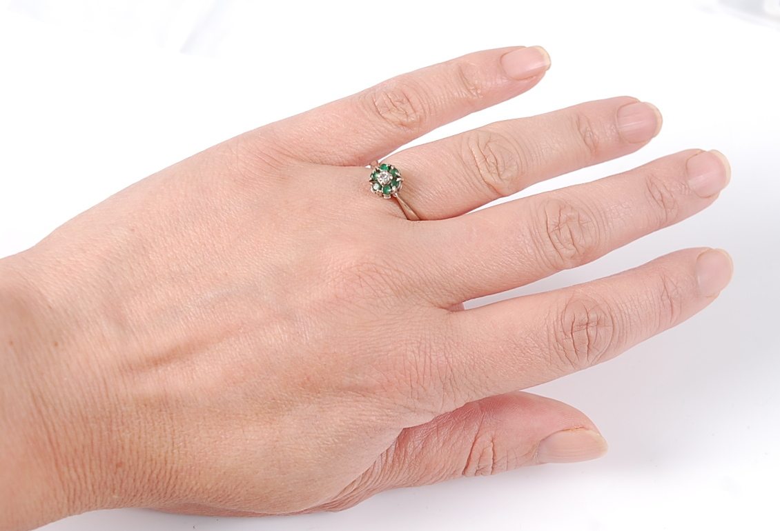 An 18ct white gold, emerald and diamond circular reverse cluster ring, the ring having a centre - Image 5 of 5