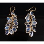 A pair of yellow metal multi moonstone drop earrings , each with 16 oval moonstone cabochons with