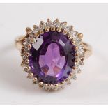 A 9ct yellow and white gold, amethyst and diamond oval cluster ring, the oval amethyst measuring