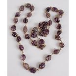 An opera length amethyst necklace, featuring 40 oval amethyst polished stone beads within wire twist