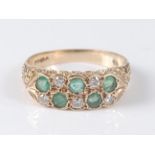 A 9ct yellow gold, emerald and diamond carved head two row half hoop eternity ring, comprising