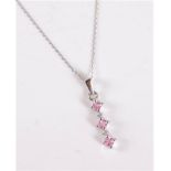 A 9ct white gold pink topaz and diamond pendant, the three round pink topaz, interspaced with a