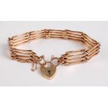 A 9ct gold gatelink bracelet, with heart shaped padlock clasp and safety chain, 14.9g, 18.5cm