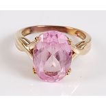 An oval synthetic pink sapphire dress ring, claw set, tested as base metal, stone dimensions 14.2
