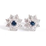 A pair of white metal and sapphire circular cluster stud earrings, each with a centre round