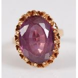 A modern yellow metal and amethyst set dress ring, the claw set amethyst measuring approx 18 x 13.