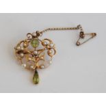 An Edwardian yellow metal peridot and seed pearl pendant, featuring twenty-four approx 1.1 to 2.