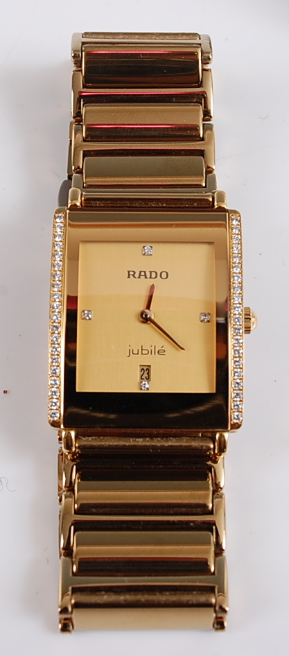 A Rado Diastar integral quartz wristwatch, the rectangular champagne dial with a diamond set at