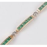 A yellow metal, emerald and diamond line bracelet, featuring eight bar shaped links, each channel