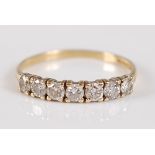 An 18ct gold diamond half hoop ring, arranged as seven four-claw set brilliants in a line setting,